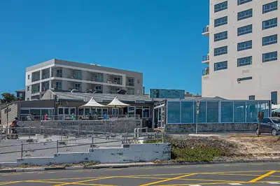 a building with a restaurant on the side of a street at Witsand 102 in Bloubergstrand