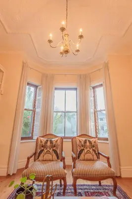 two chairs in a room with windows and a chandelier at Bonne Esperance Villa in Stellenbosch