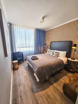 a bedroom with a bed and a large window at Portico 1103 in Cape Town