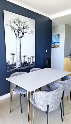 a meeting room with a white table and chairs at Portico 1103 in Cape Town