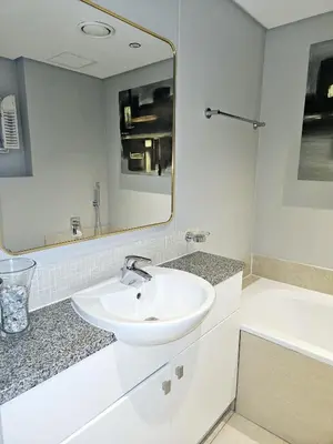 a bathroom with a sink and a mirror and a tub at Portico 1103 in Cape Town