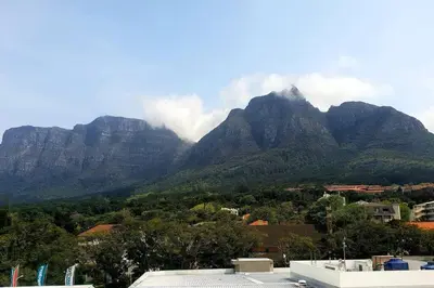 a view of a mountain range with clouds in the sky at The Rondebosch Easy Living in Cape Town
