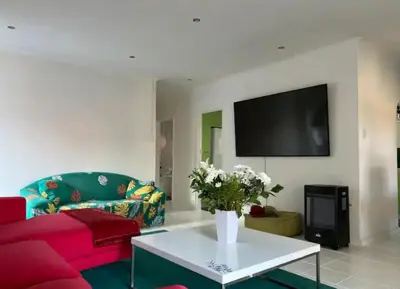 a living room with a red couch and a table at BREATHE On SOUTH in Cape Town