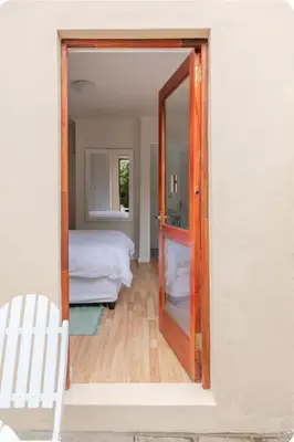 a room with a door leading to a bedroom at Lux Suite for 2 - Sunset Beach in Cape Town