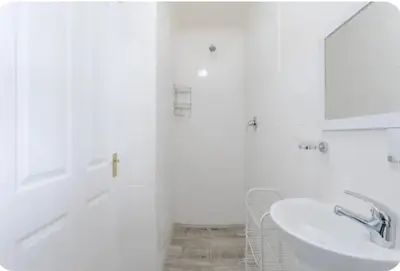 a white bathroom with a sink and a mirror at Lux Suite for 2 - Sunset Beach in Cape Town