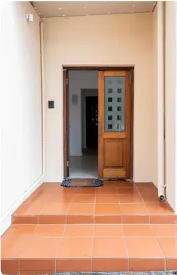 an empty room with a door and a tile floor at Lux Suite for 2 - Sunset Beach in Cape Town