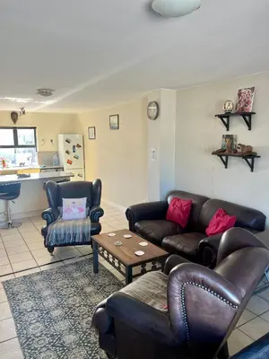 a living room with couches and a table at The Hippo Luxury Apartment in Cape Town