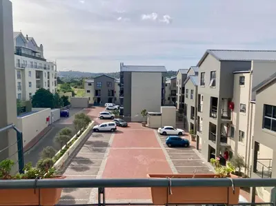 a city street with cars parked in a parking lot at The Hippo Luxury Apartment in Cape Town