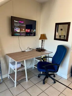 an office with a desk and a blue chair at The Hippo Luxury Apartment in Cape Town