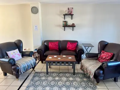 a living room with two couches and a coffee table at The Hippo Luxury Apartment in Cape Town