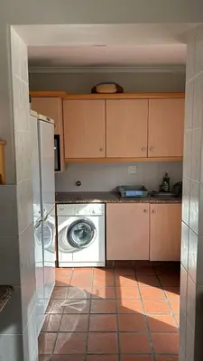 a kitchen with a washer and a washing machine at House Simon in Somerset West