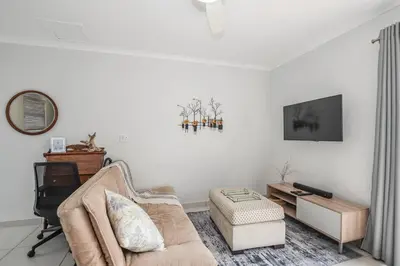 a living room with a couch and a chair at WiFi & Solar at Studio on Morgenster in Cape Town