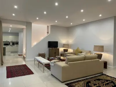 a living room with a couch and a table at 29nTanglewood cr, Sunset Links residential Estate in Cape Town