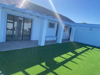 a rendering of a house with a green lawn at 32 On Gill Road Self Catering in Cape Town
