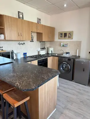 a kitchen with a counter and a washer and dryer at The Muscadel - Paarl - Self Catering Apartment in Paarl