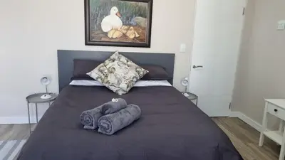 a bedroom with a bed with three towels on it at Lorenza's Place in Stellenbosch