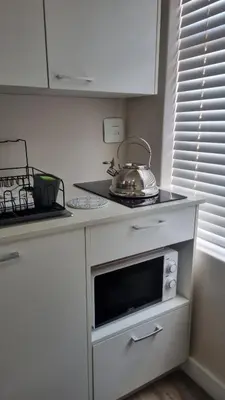 a kitchen counter with a tea kettle on top of a microwave at Lorenza's Place in Stellenbosch