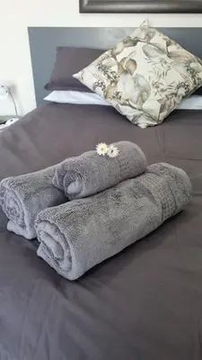 a pile of towels sitting on top of a bed at Lorenza's Place in Stellenbosch