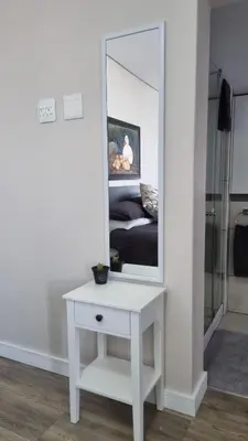 a white dressing table with a mirror on a wall at Lorenza's Place in Stellenbosch