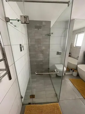 a bathroom with a glass shower with a toilet at Blouberg Sea View in Bloubergstrand