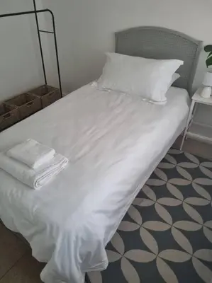 a white bed with white sheets and pillows on it at Lanaria 9, Betty's Bay in Clareport