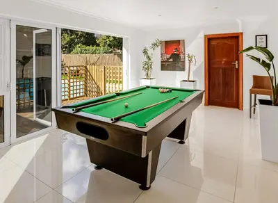 a billiard room with a pool table in a house at Kiefern Haus Main House in Cape Town