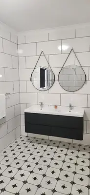 a bathroom with a sink and two mirrors at Villa Des Roses in Paarl