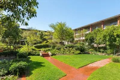 a garden in front of a building at Mayfair Apartments in Cape Town