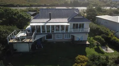 an aerial view of a large house with a porch at Seaview on 2822 - Romantic Ocean Studio in Bettyʼs Bay