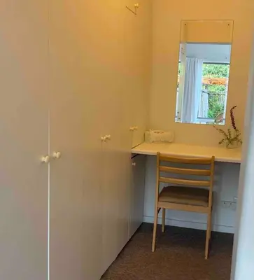 a room with a desk with a chair and a mirror at Garden studio close to Wine Farms in Somerset West