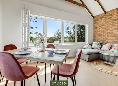 a dining room with a table and chairs at Kiefern Haus Studio Apartment in Cape Town