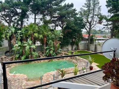 a view of a swimming pool from a balcony at SharronDeez in Cape Town