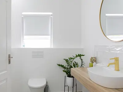 a white bathroom with a sink and a mirror at La Dolce Vita Gordon’s Bay in Gordonʼs Bay