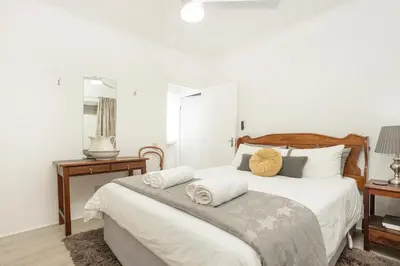 a bedroom with a bed with two towels on it at Inn 201 in Hermanus