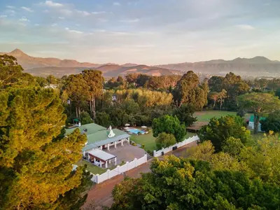 an aerial view of a house with trees and mountains at La Felicita Boutique Self Catering Villas in Somerset West