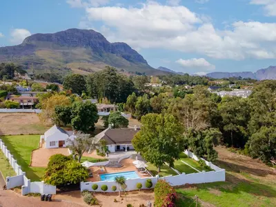 an aerial view of a house with mountains in the background at La Felicita Boutique Self Catering Villas in Somerset West