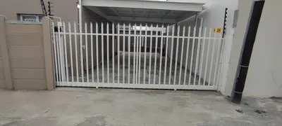 a white gate in a garage with a door at Lasai Accommodation in Worcester