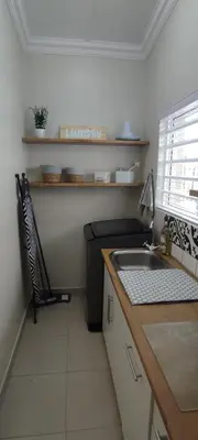 a small kitchen with a sink and a chair at Lasai Accommodation in Worcester