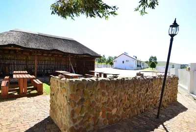 a stone wall and a street light next to a building at D'Aria Guest Cottages in Durbanville