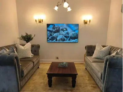 a living room with two couches and a coffee table at Petites Bulles Lodge in Stellenbosch