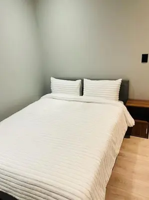 a white bed with two pillows on top of it at Rachel`s Guest House - Cape Town in Cape Town