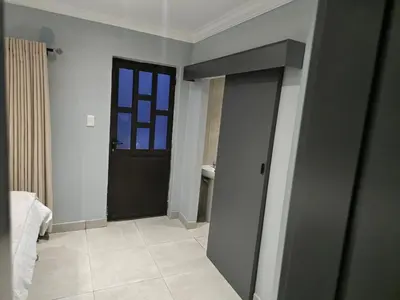 a bathroom with a black door and a window at Rachel`s Guest House - Cape Town in Cape Town