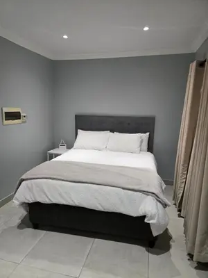 a bedroom with a large bed in a room at Rachel`s Guest House - Cape Town in Cape Town