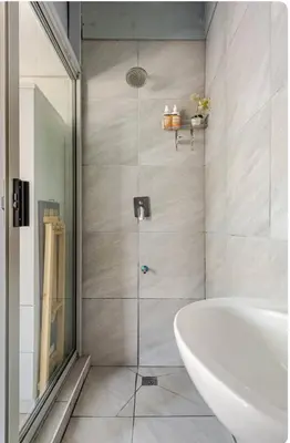 a bathroom with a shower with a tub and a sink at A Room with private Entrance in Cape Town