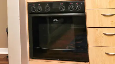 a black oven in a kitchen with wooden cabinets at Royal Beauty in Paarl