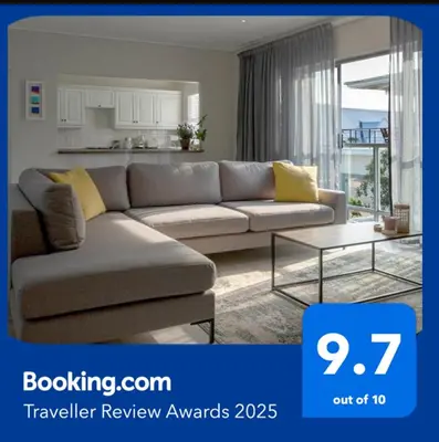 a living room with a couch and a table at Twin Gables, centrally located 2 bedroom apartment in Hermanus
