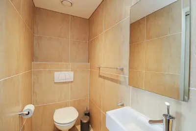 a bathroom with a toilet and a sink at Ocean View 304 Luxury Self Catering Apartment Strand Western Cape South Africa in Cape Town