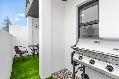 a kitchen with a grill and a window at Beach Break Two in Cape Town