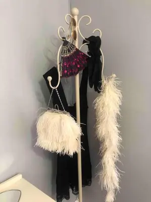 a rack with some black and white clothes and feathers at Gatsby Suite, with pool in quiet area, close to town in Stellenbosch