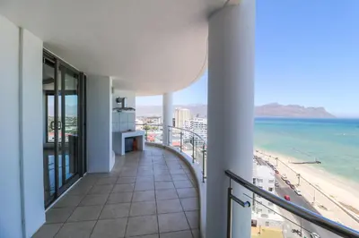 a balcony with a view of the beach at 1402 Hibernian Towers Luxury Self Catering Apartment Strand Western Cape South Africa in Cape Town